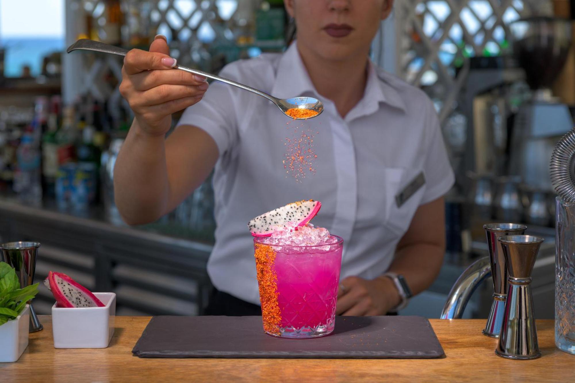 Rodos Palladium Leisure & Wellness Kallithéa Exterior foto A bartender adding a garnish to a cocktail